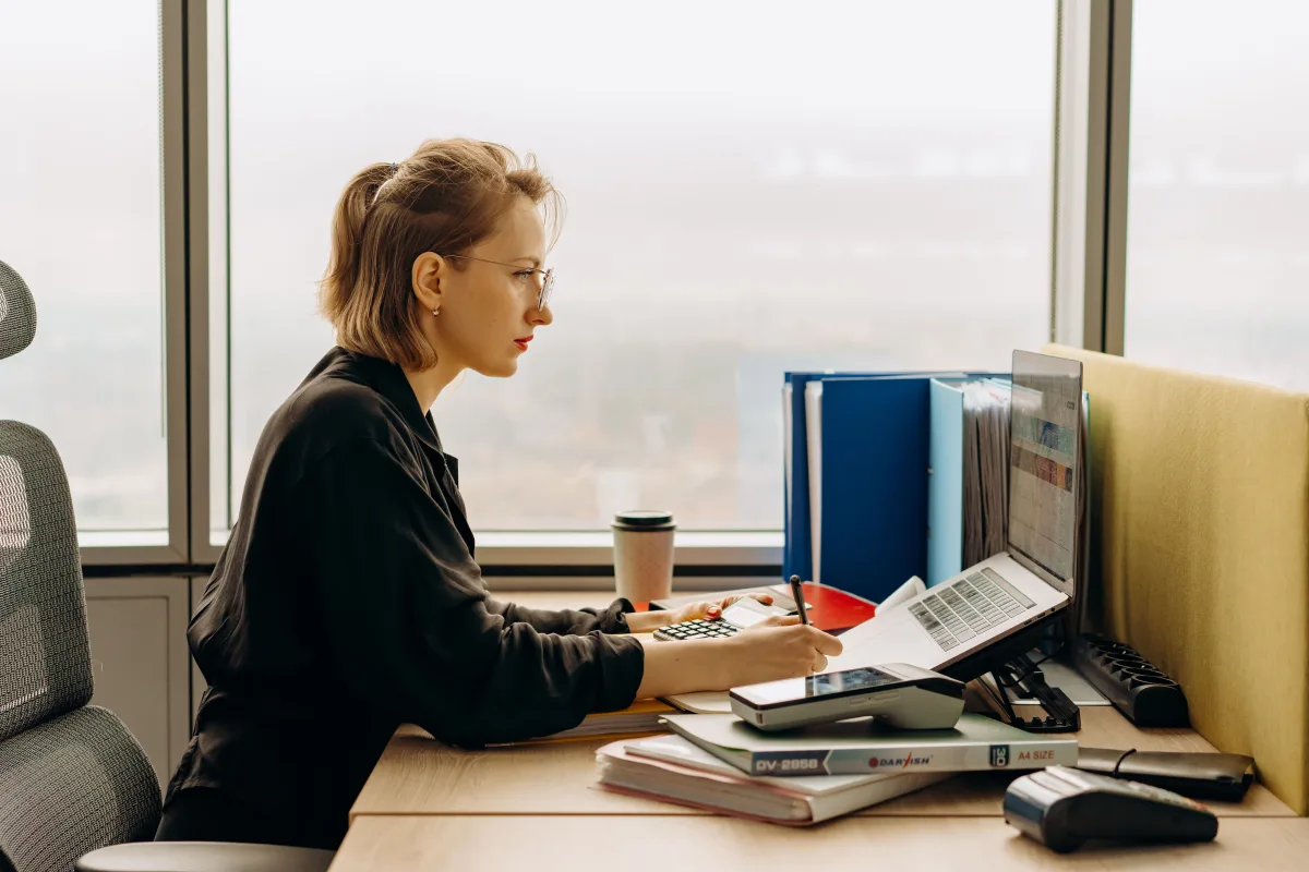 Small business owner working on laptop with accounting software dashboard open