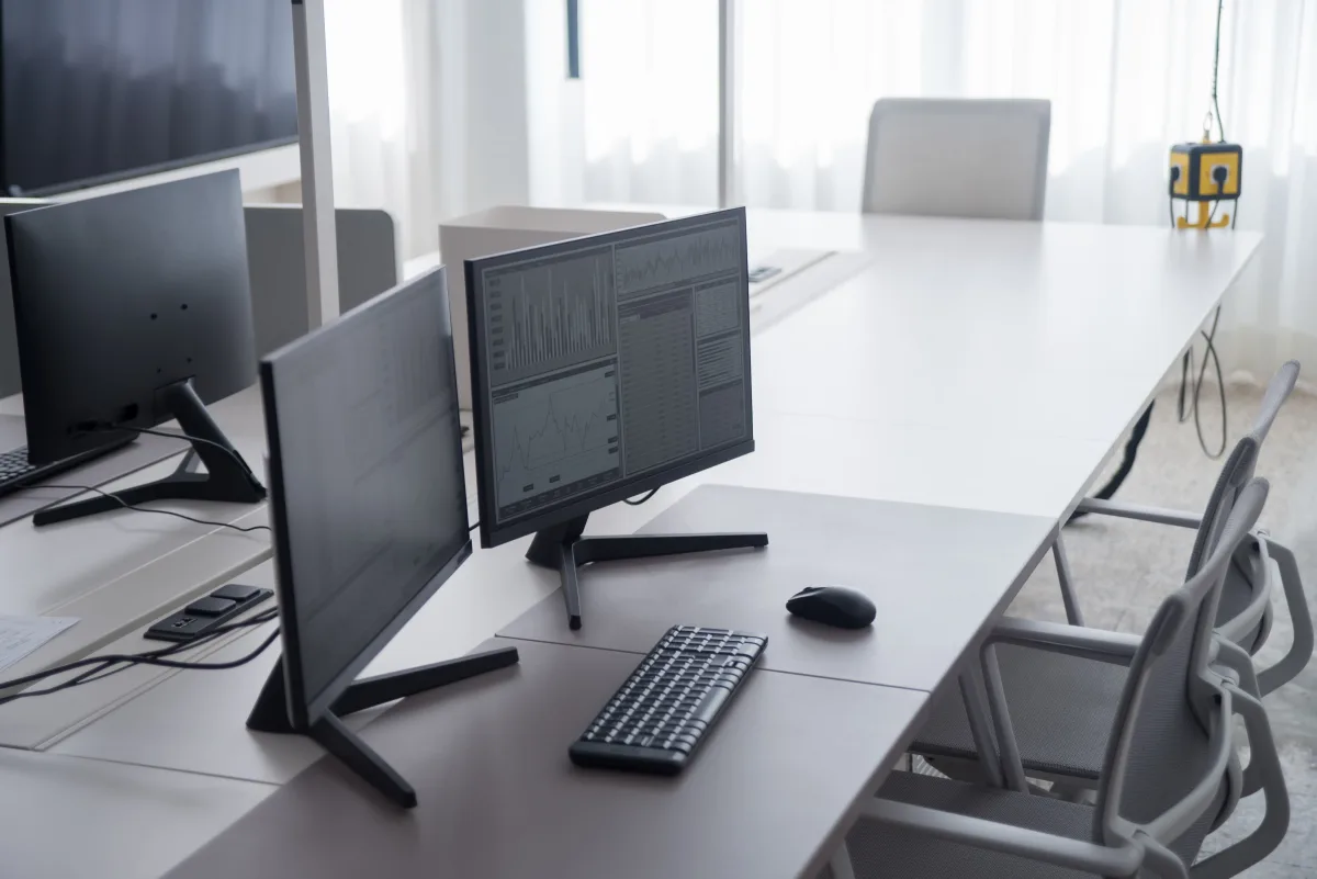 Clean office desk with large monitor and ergonomic setup for professional use