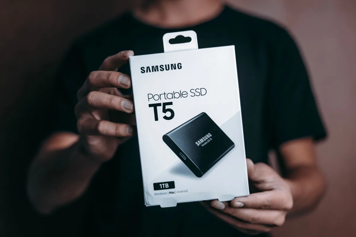 Person holding a Samsung T5 Portable SSD box