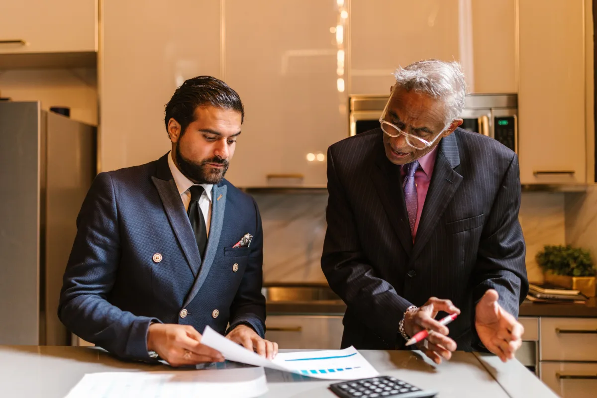 Two professionals discussing financial documents in a modern office