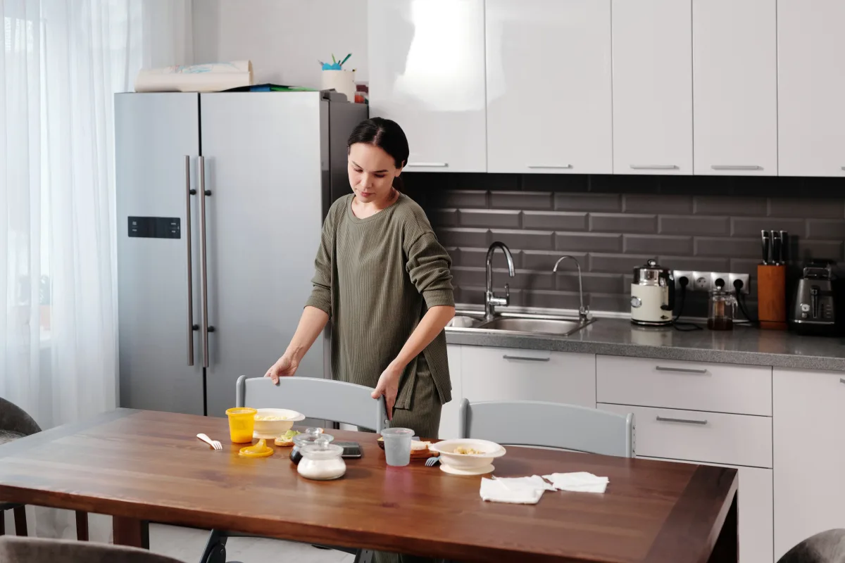 Woman organizing kitchen — home management lifestyle