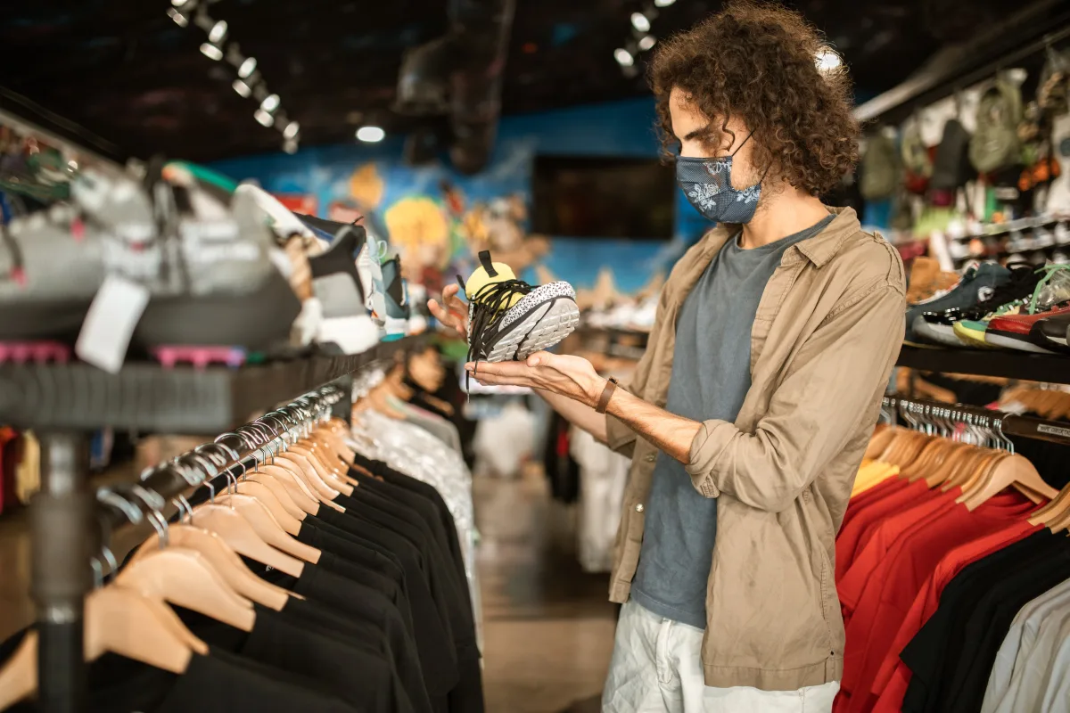 Person inspecting clothing quality in a retail store