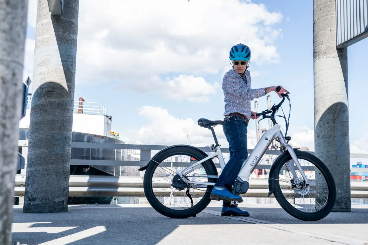 Cyclist riding an electric bike under a clear blue sky