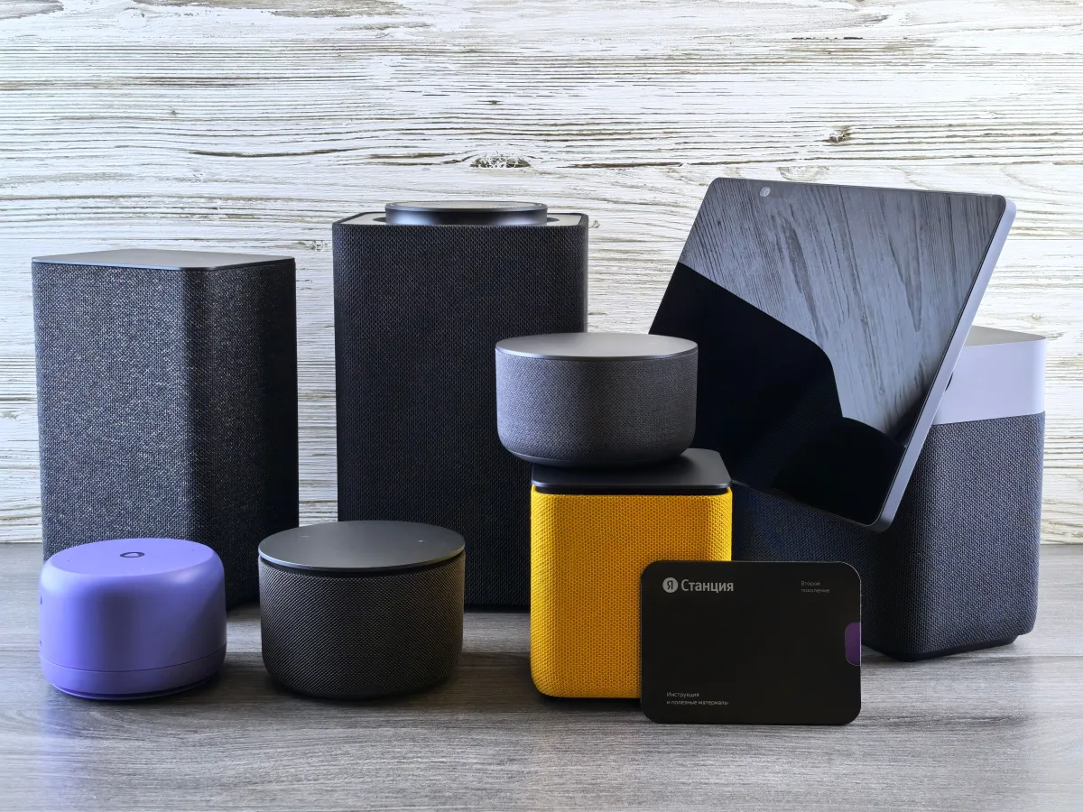 Various smart home speakers and displays on wooden surface