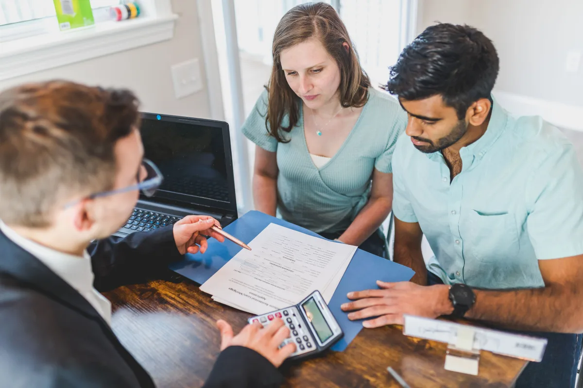 Young couple reviewing mortgage options with a loan officer