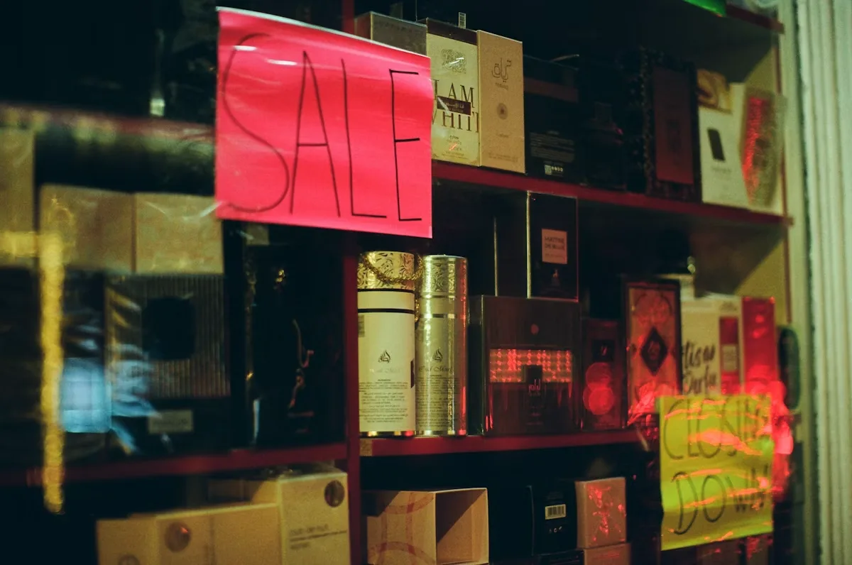 Shelves of perfume bottles with sale signs at a retail store