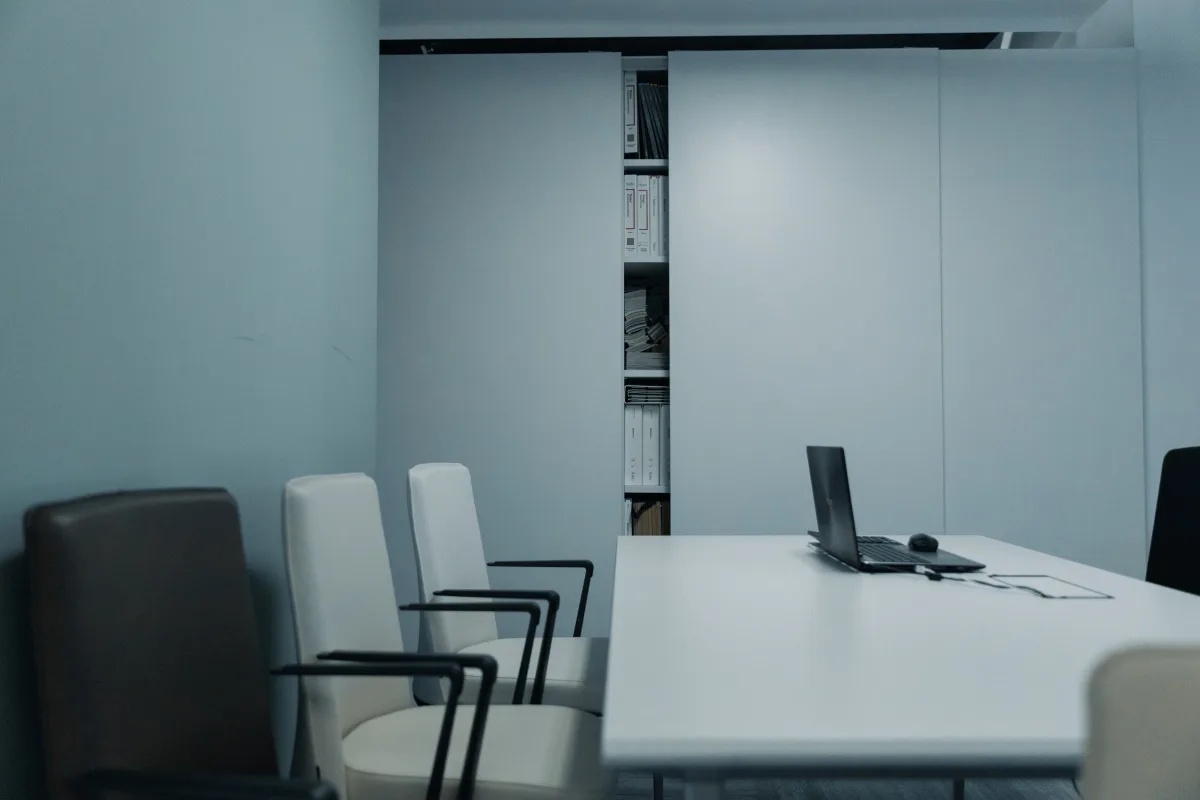 Sleek conference room with a laptop on the table, representing a business software evaluation meeting