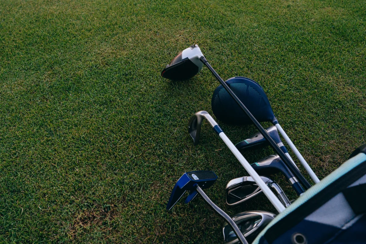 Golf clubs laid out on a green fairway — best golf equipment deals 2026