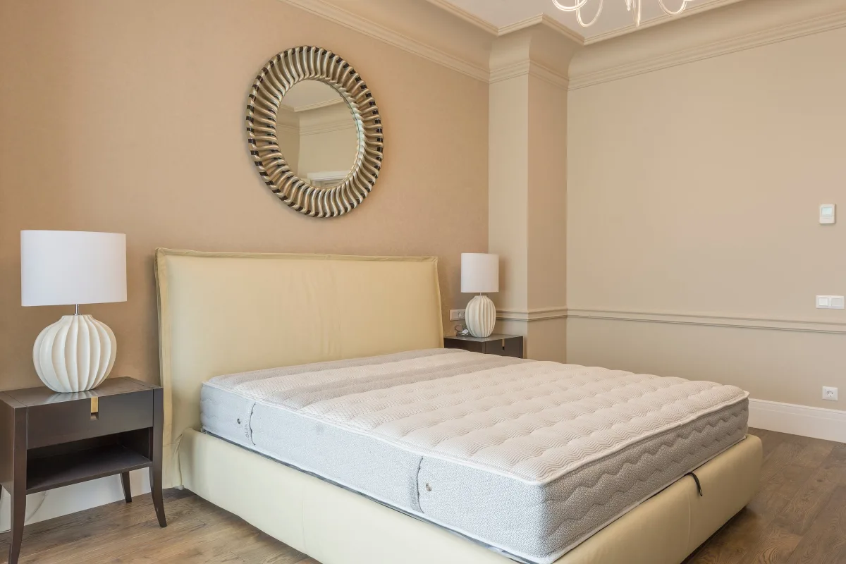 Modern bedroom with a neatly made bed and soft natural lighting
