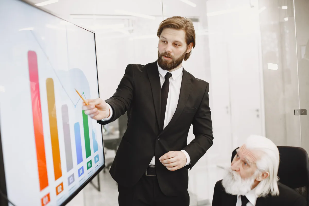 Two professionals discussing data trends during a presentation