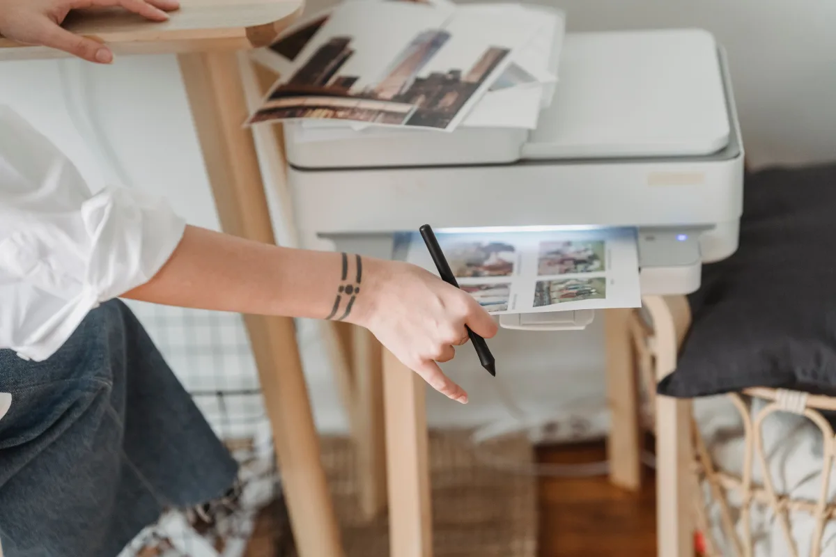 Person reviewing printed documents at a home desk