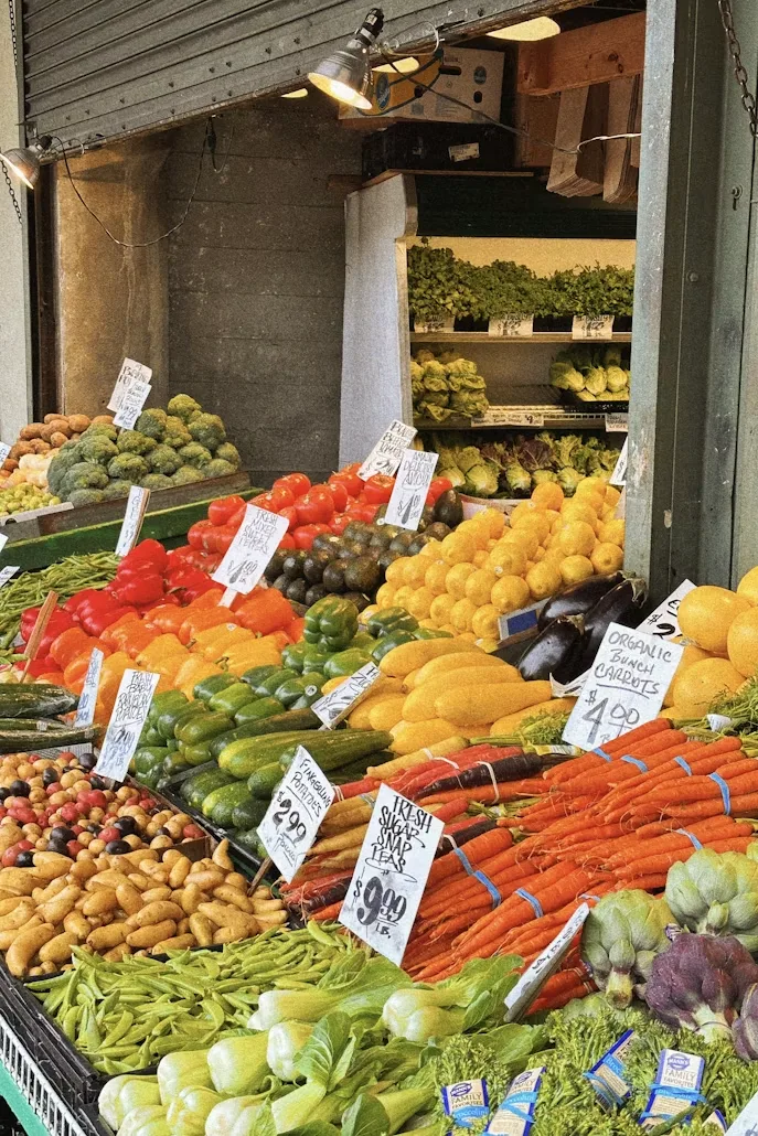 Large colorful display of fresh fruits and vegetables at Pike Place Market