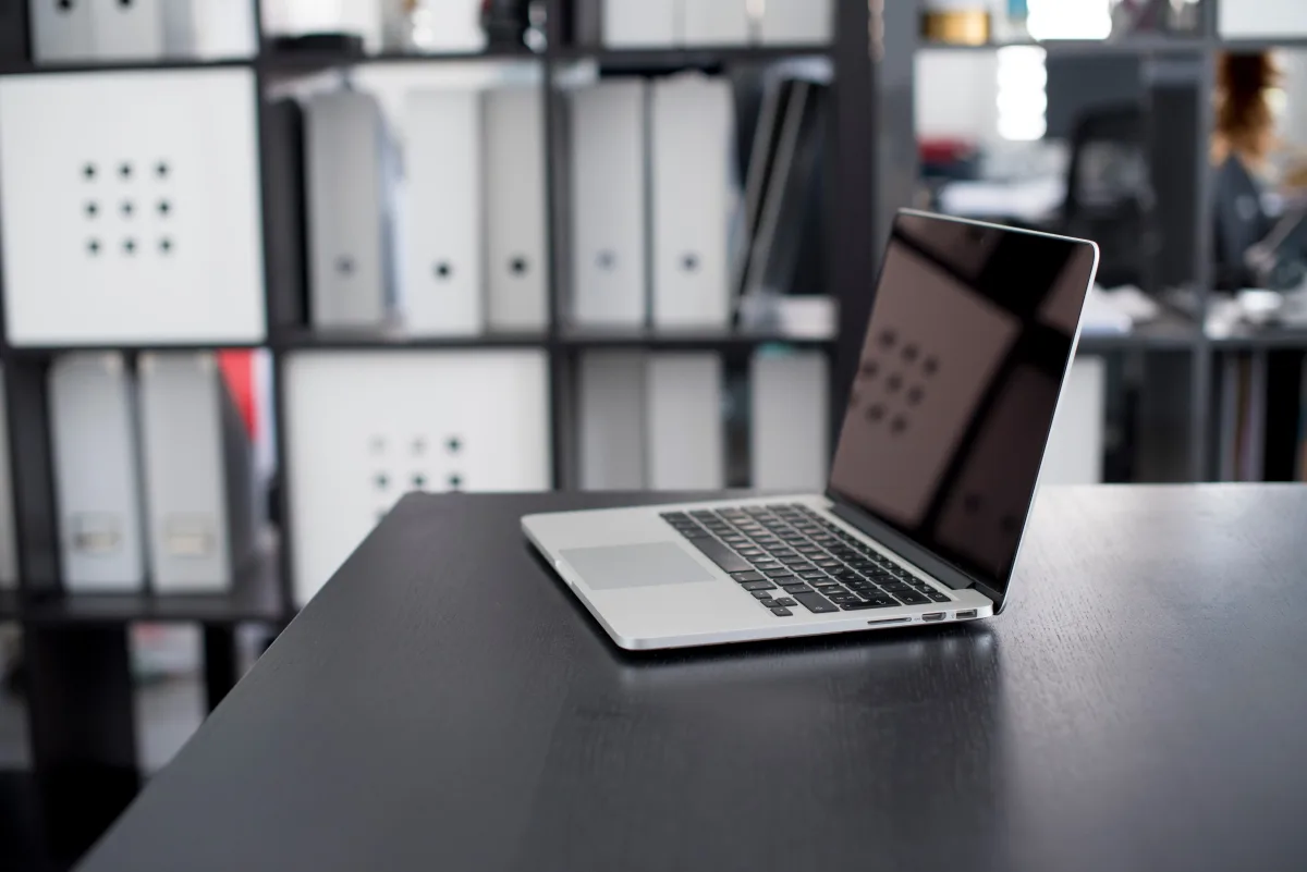 MacBook Pro on a minimalist office desk representing 2026 office software and hardware decisions