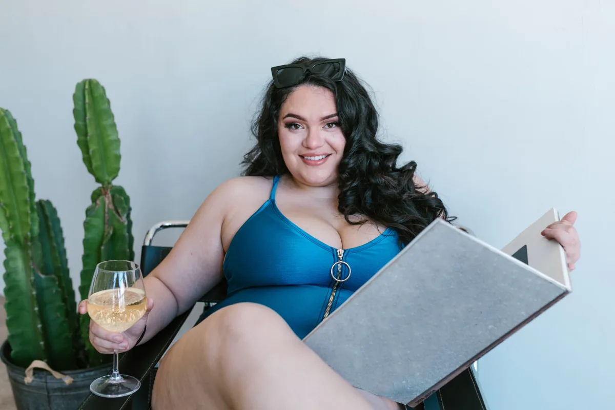 Plus-size woman relaxing in a blue swimsuit representing casual and trend-led plus-size style