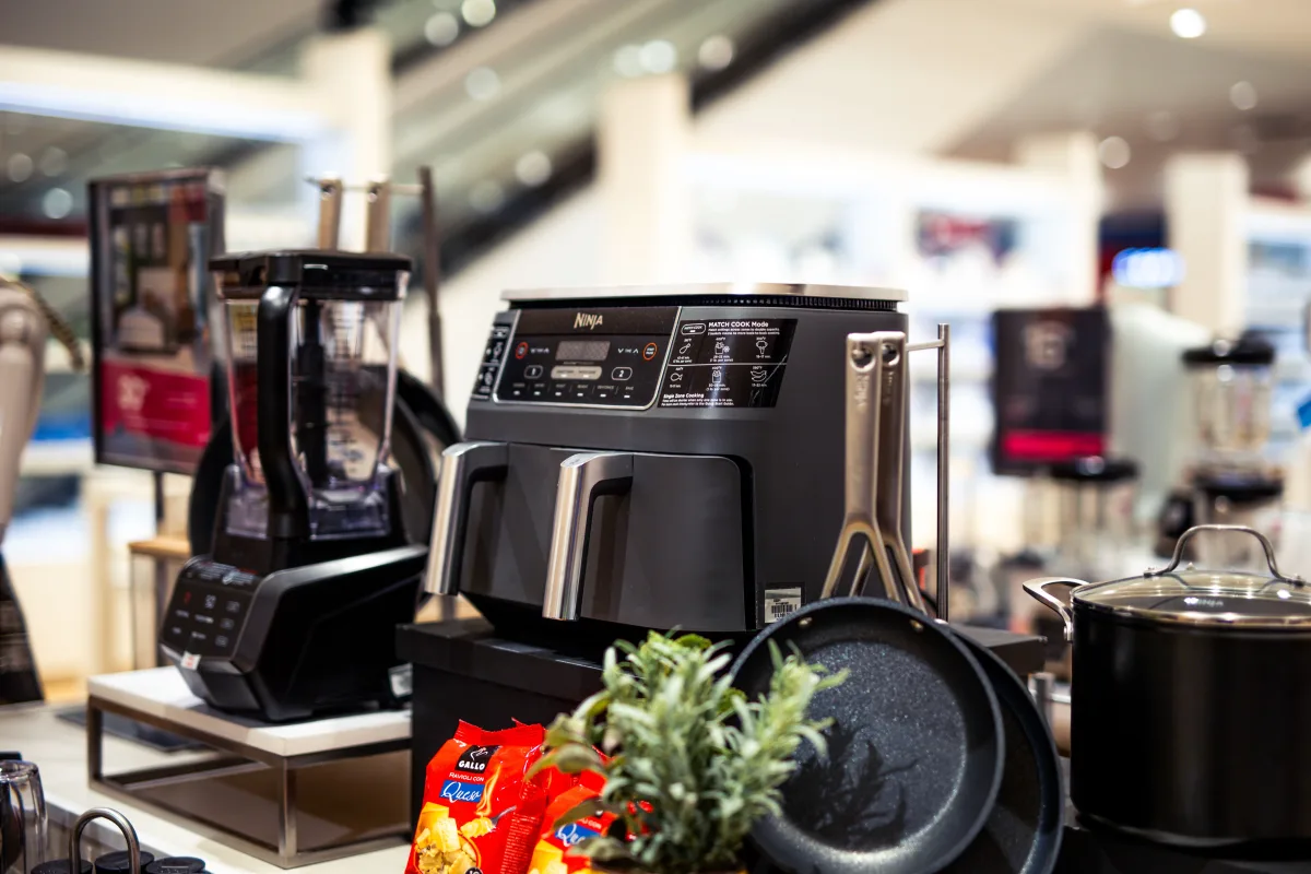 Kitchen appliance showroom displaying Energy Star rated refrigerators and ranges