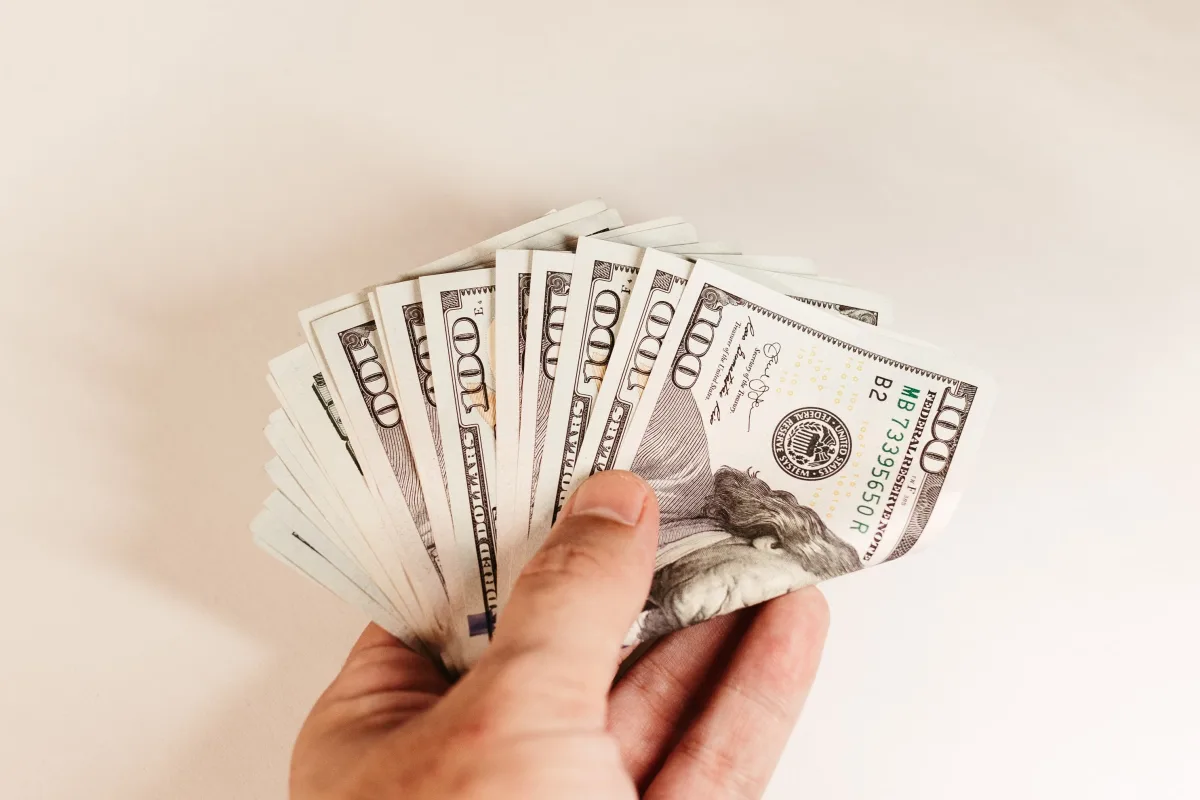 Hand holding cash representing personal loan proceeds