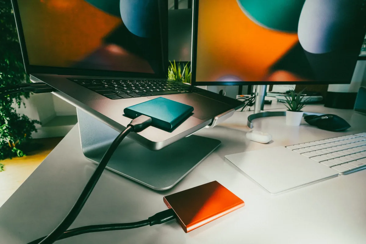 Home office desk setup with laptop and external drives for backup