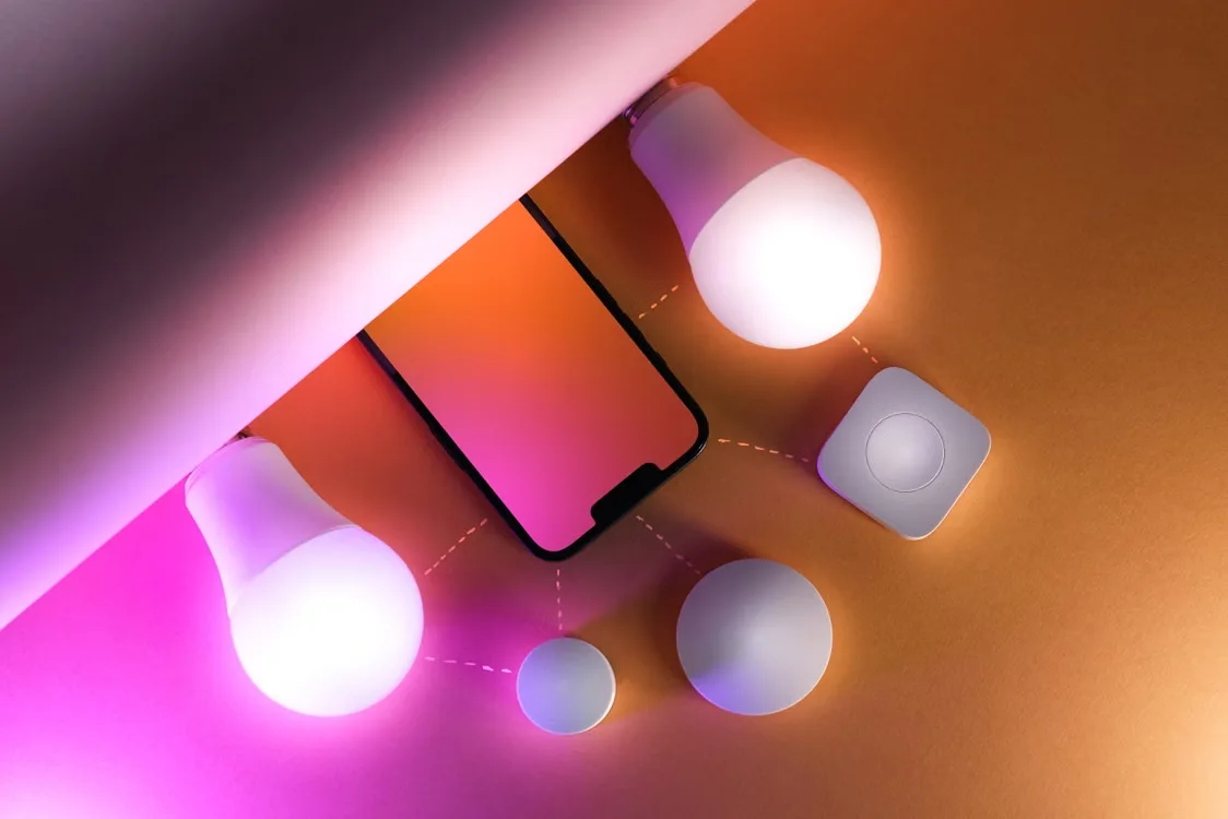 Collection of colorful smart bulbs arranged as a flat lay on a white surface
