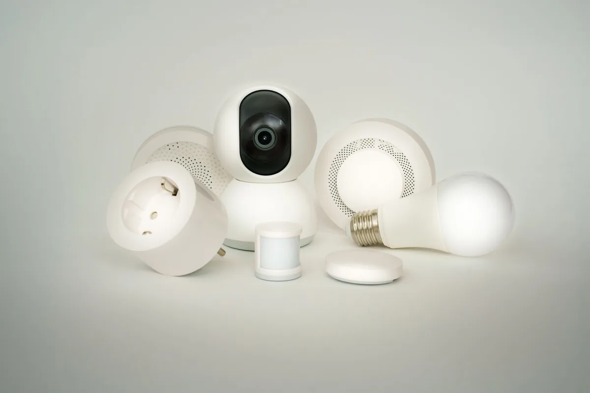 Collection of smart home devices including speakers and displays on white background
