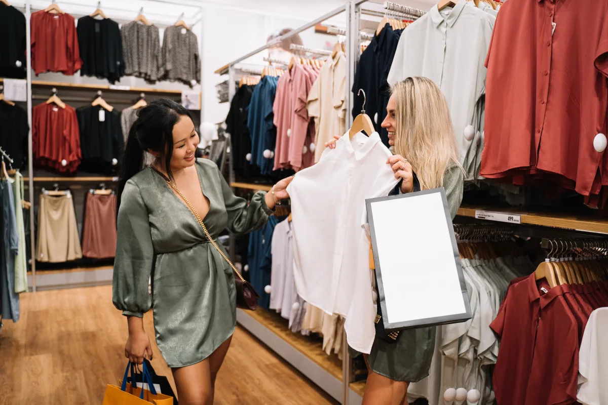 Shoppers in conversation choosing between garments