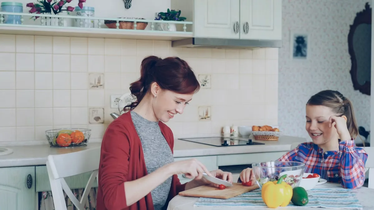 Mother and daughter cooking together in a bright kitchen, cutting vegetables for dinner