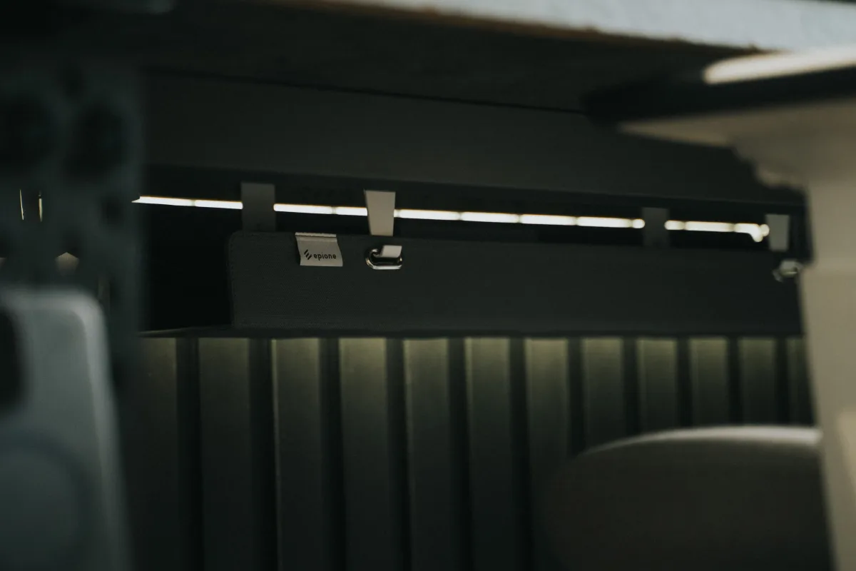 Under-desk cable tray with organized cables in a clean workspace