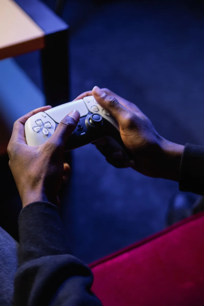 Close-up of hands holding a video game controller