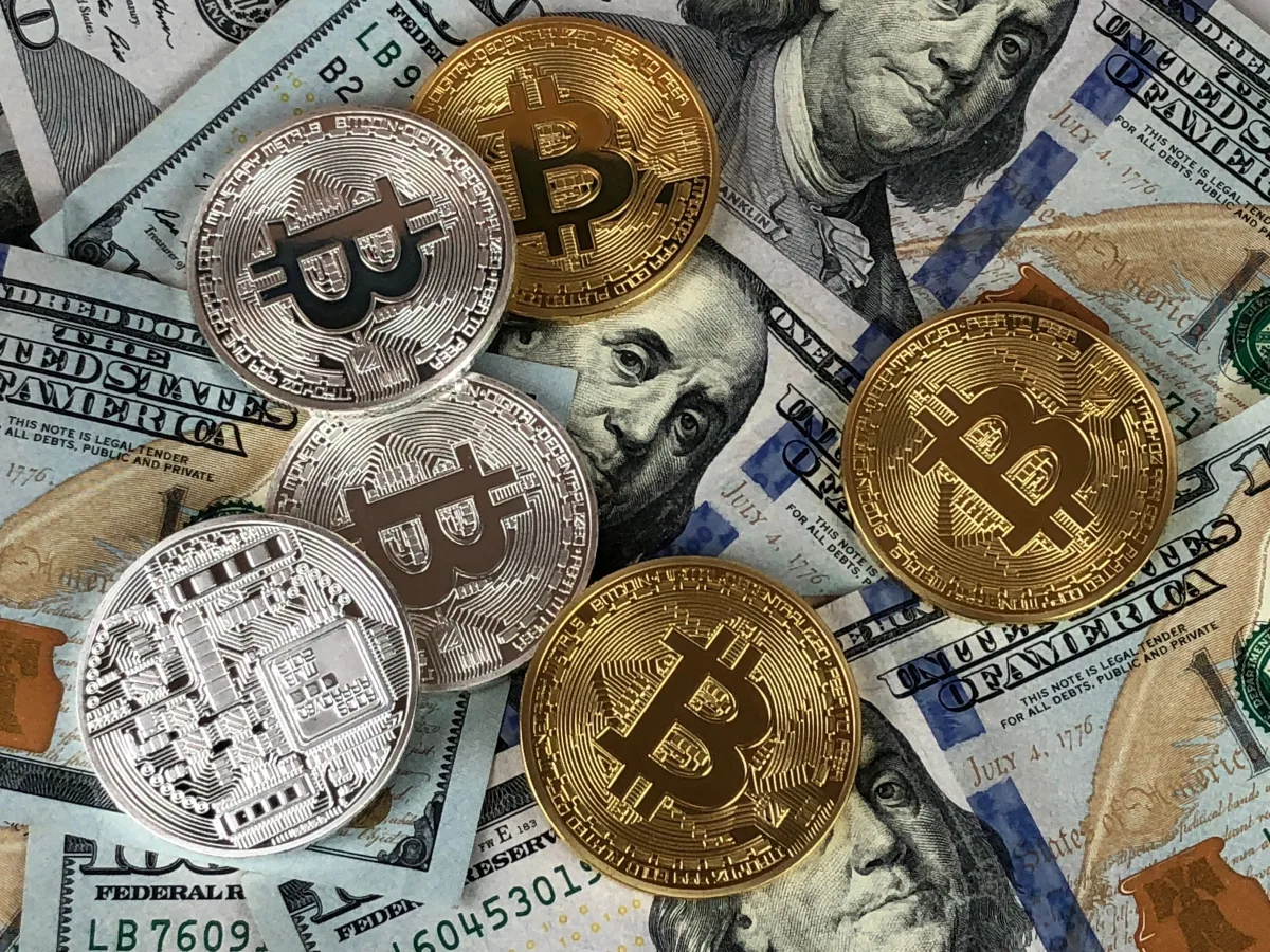 Budget planning calculator and coins representing e-learning total cost of ownership