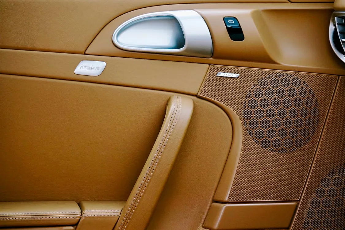 Brown leather luxury EV interior with Bose speaker panel