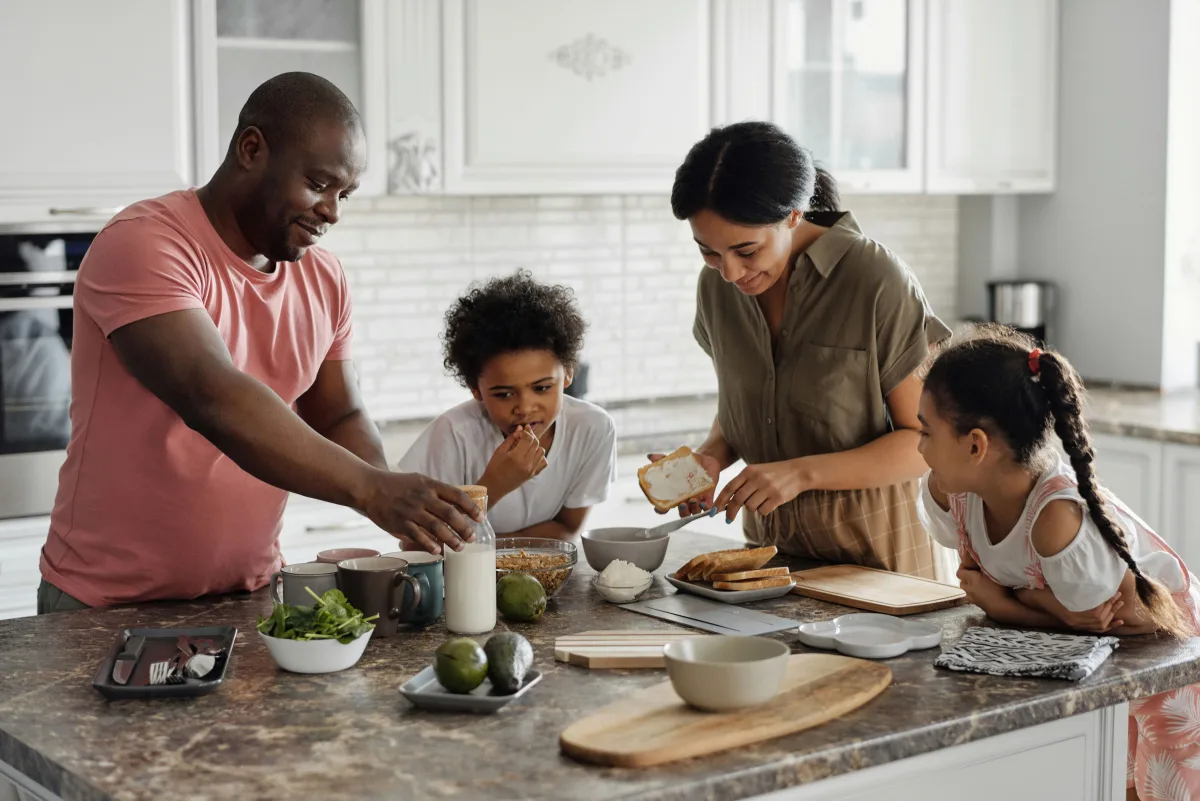 Family cooking fresh ingredients together in kitchen — meal kit subscription