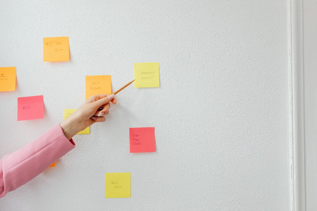 Person organizing project with colorful sticky notes