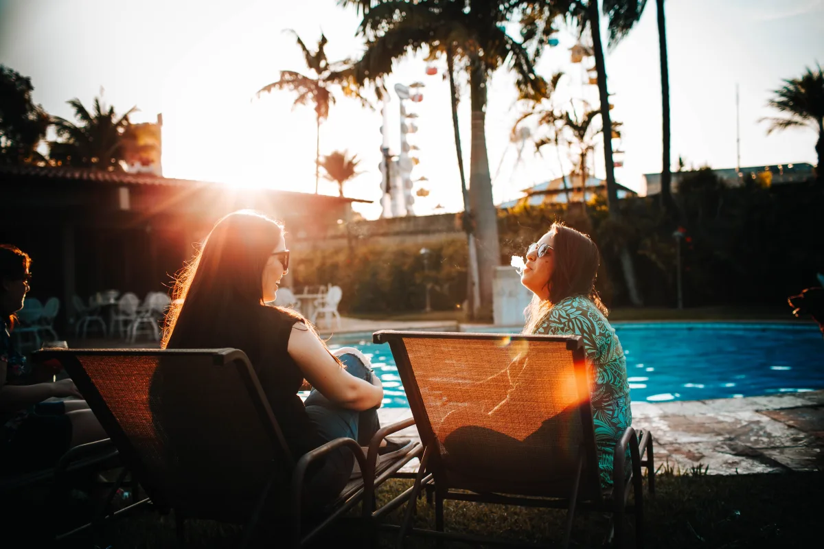 Two lounge chairs by a pool showing typical outdoor furniture setup