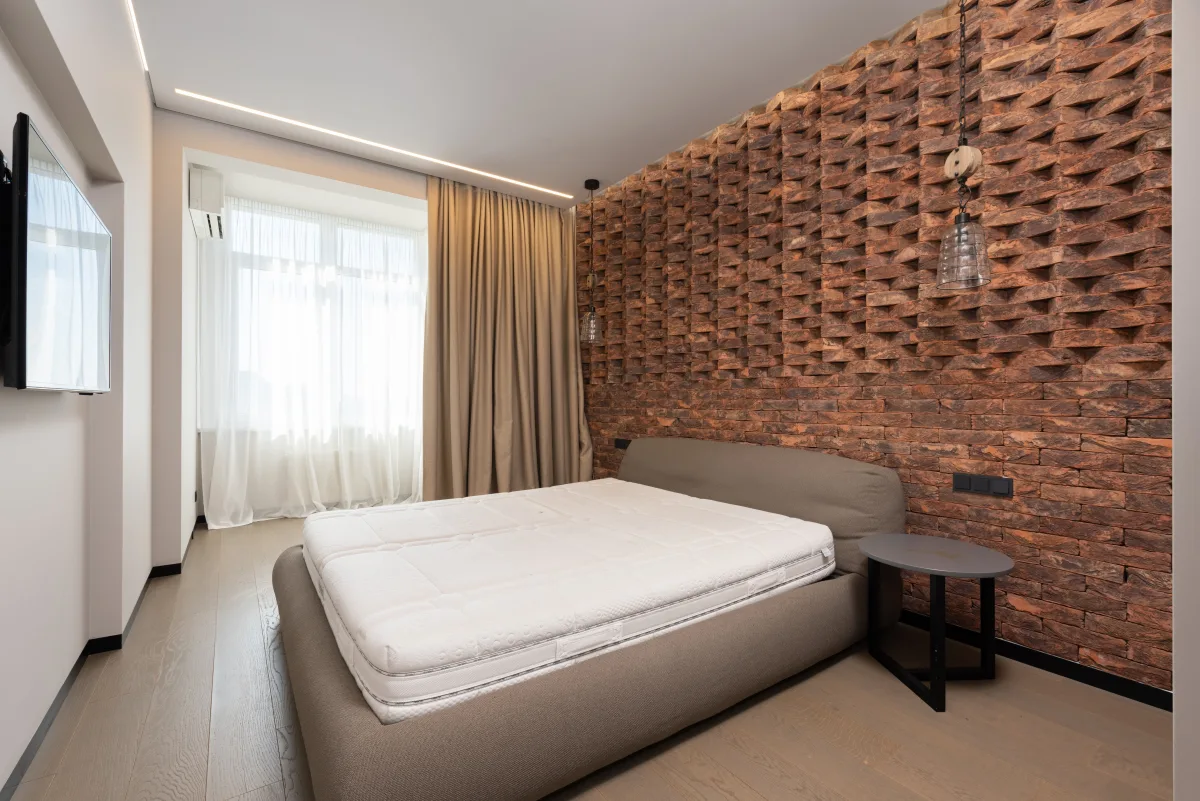 Person lying on their back in a bright, well-furnished bedroom