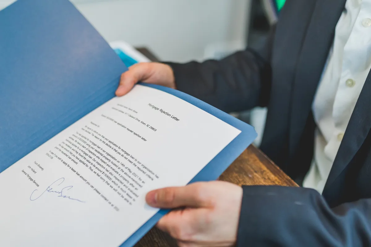 Hands reviewing a real estate purchase contract