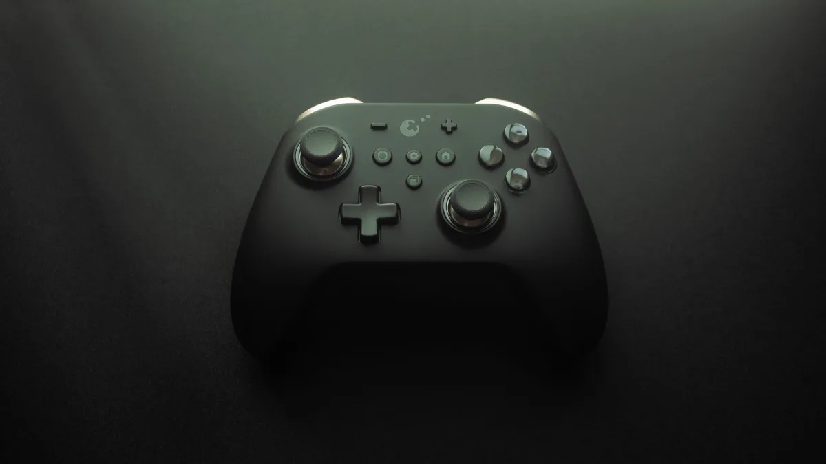 A modern gaming controller on a black surface — cheap game keys 2026 buying guide