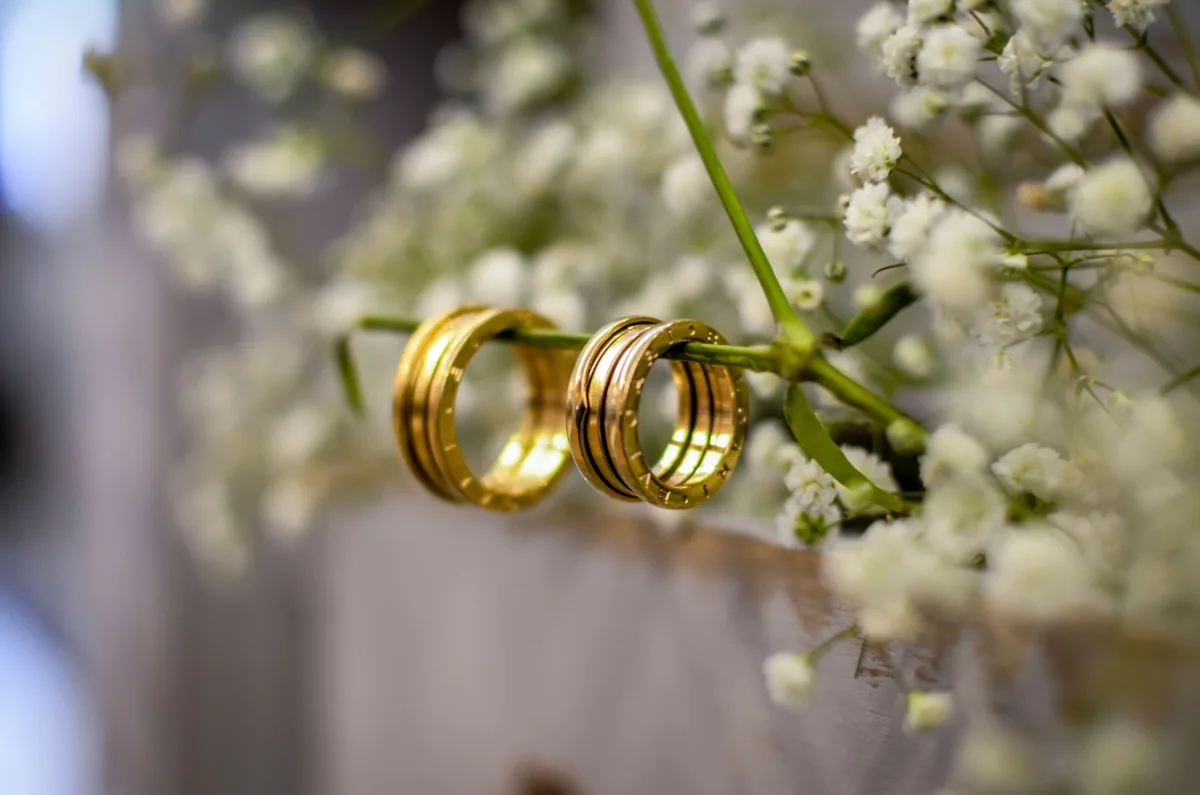 Close-up of two gold wedding rings placed side by side with shallow depth of field