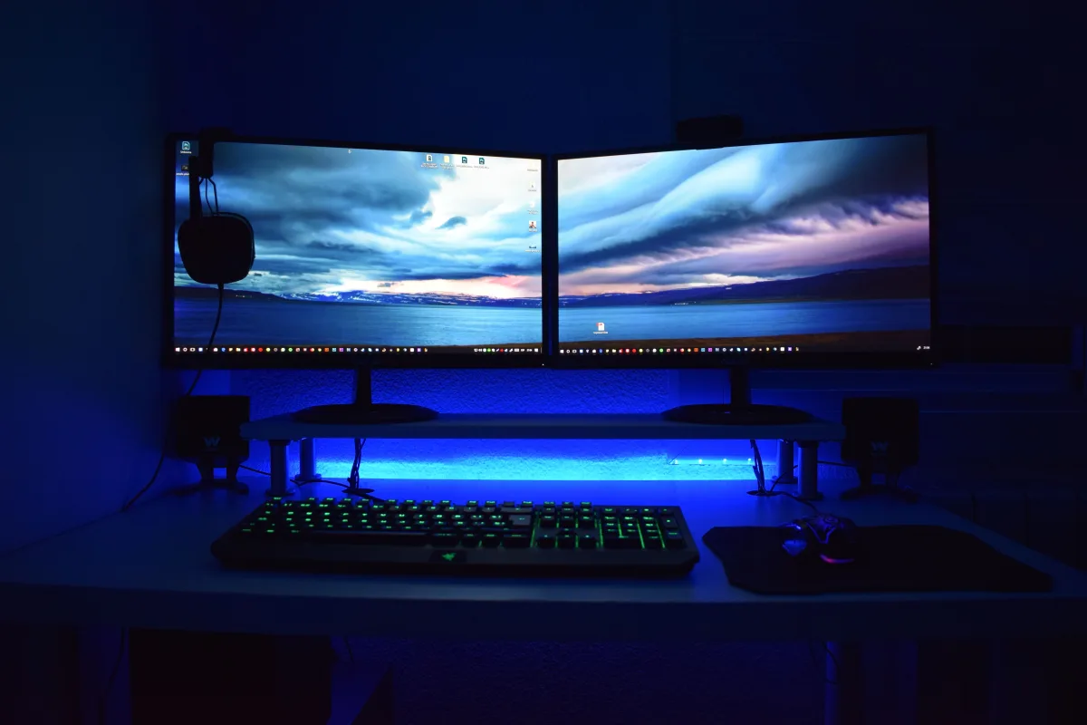 Dual monitors with blue ambient desk lighting