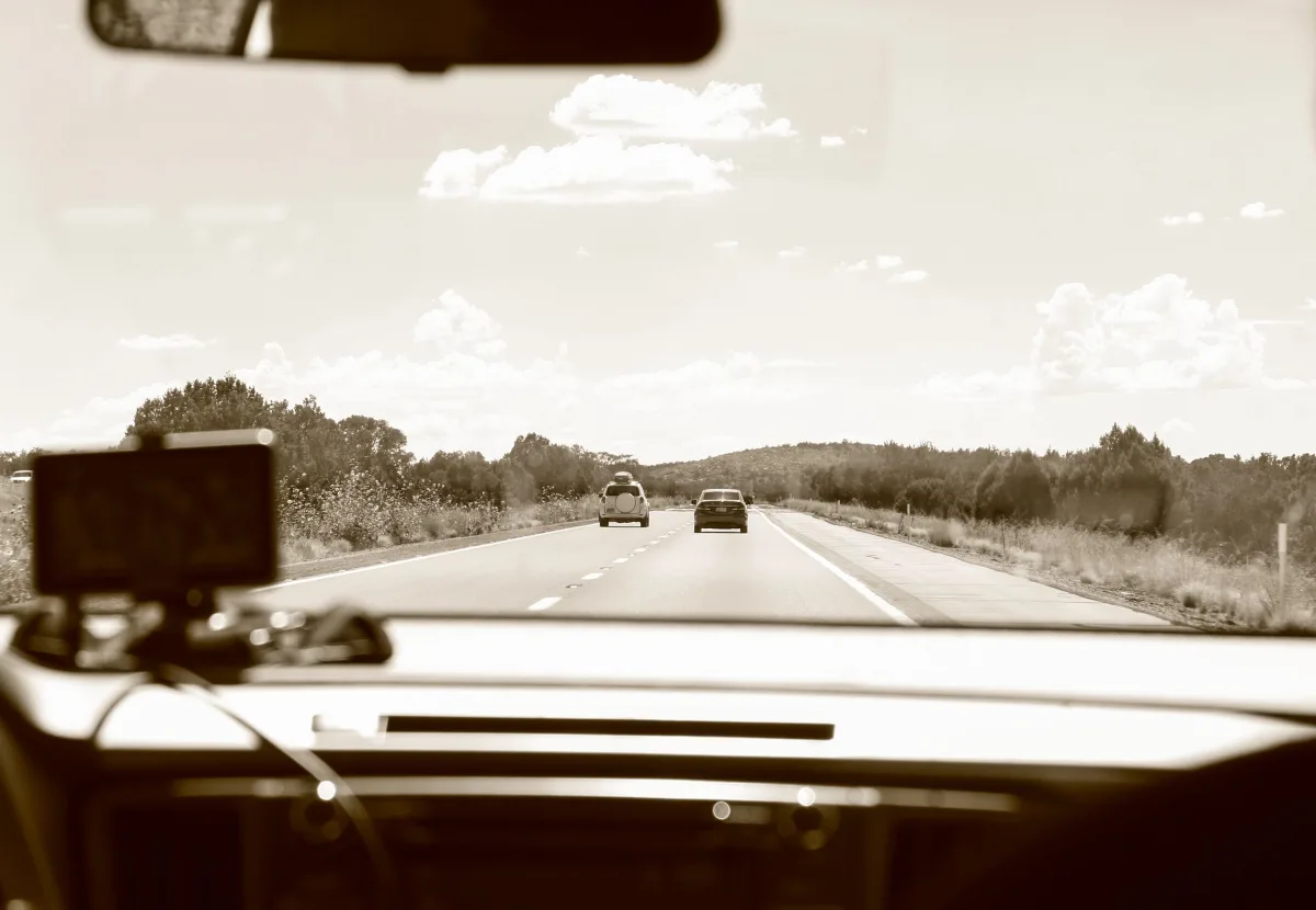 Driver on a long highway road trip where radar detector choice matters for cross-country travel