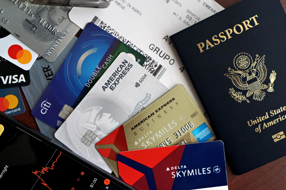 Credit cards, passport, and boarding pass on a wooden surface