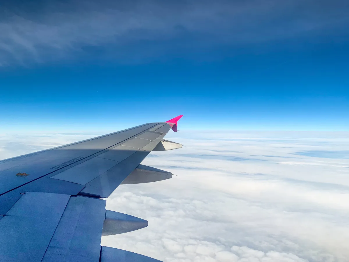 Aerial view above clouds from airplane window