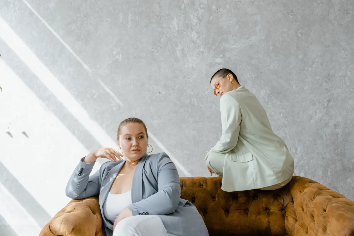 Two stylish plus-size women in suits representing sustainable and inclusive fashion