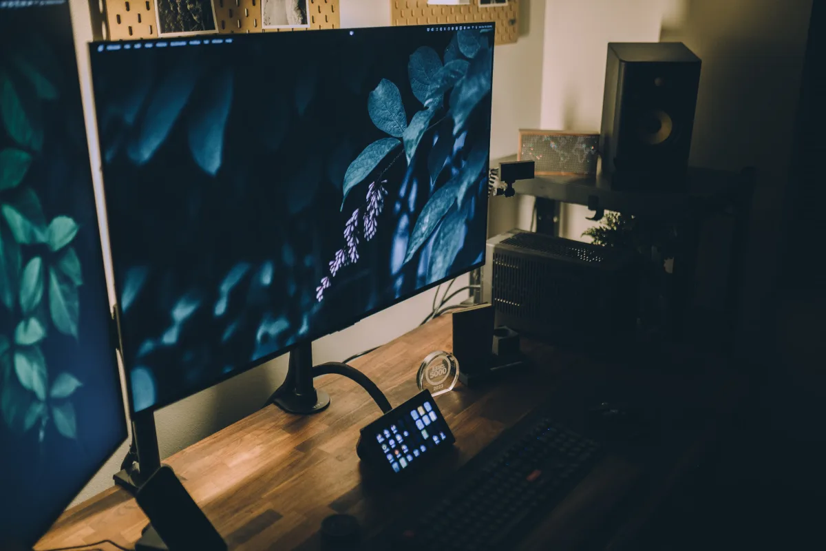 Minimalist workspace with dual monitor setup and wooden desk