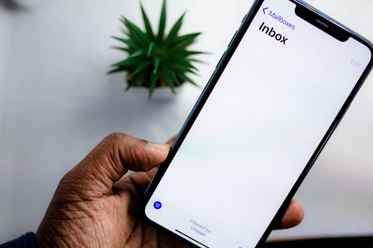 Content creator checking email newsletter on smartphone