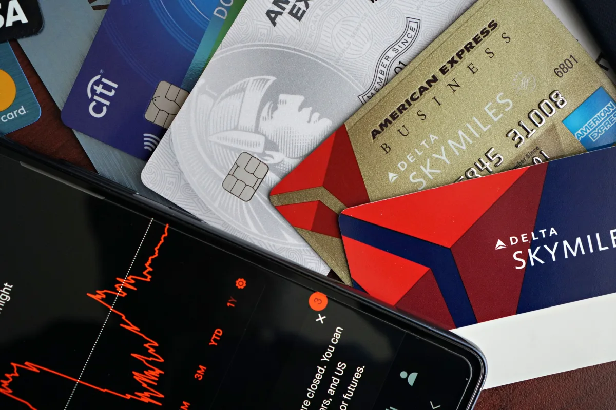 Credit cards and financial market data on a smartphone — personal finance 2026