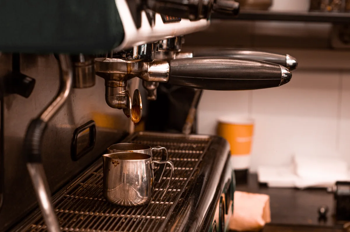 Detailed view of a drip coffee maker pouring coffee into cups — best drip coffee makers 2026