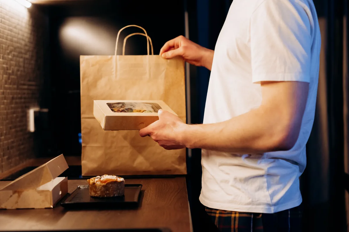Person unboxing a meal kit delivery in a modern kitchen
