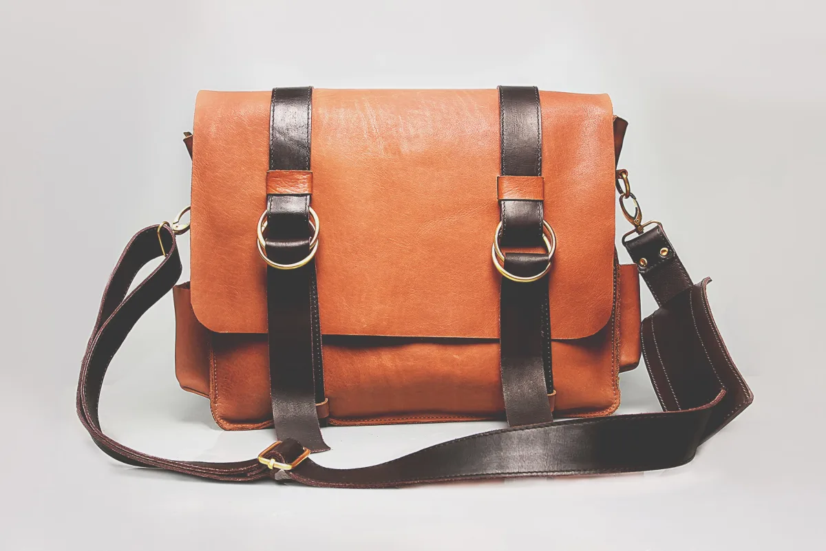 Luxury designer leather handbags displayed on a white surface