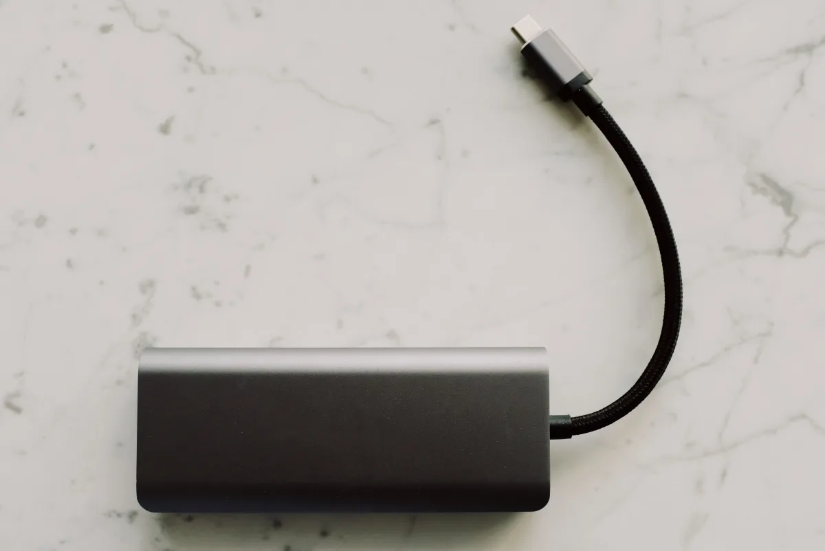 Sleek portable power bank with USB-C cable on marble, ideal for travel